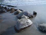 Winterstrand auf Usedom: Noch halten sich die Eiskappen auf Steinen.
