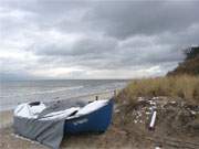 Der Ostseestrand von Stubbenfelde: Ein Fischerboot im ersten Schnee.