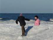 Kinderspiel auf den Eisbergen am Ostseestrand: Winterurlaub auf der Ostseeinsel Usedom.