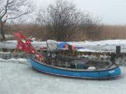 Im Eis: Fischerboot im Achterwasserhafen des Bernsteinbades Loddin auf Usedom.